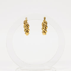 Pair of gold hoop earrings on a white background