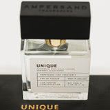 Unique Ampersand perfume bottle with black cap on a white background