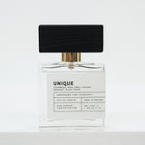 Perfume bottle labeled 'UNIQUE' on a white background