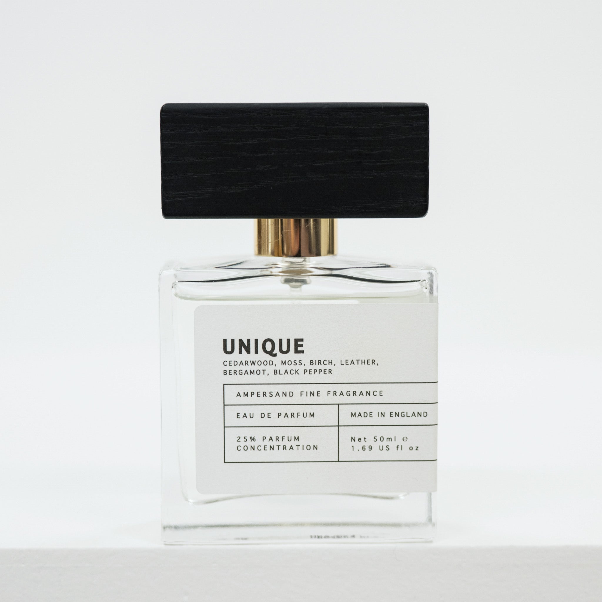 Perfume bottle labeled 'UNIQUE' on a white background