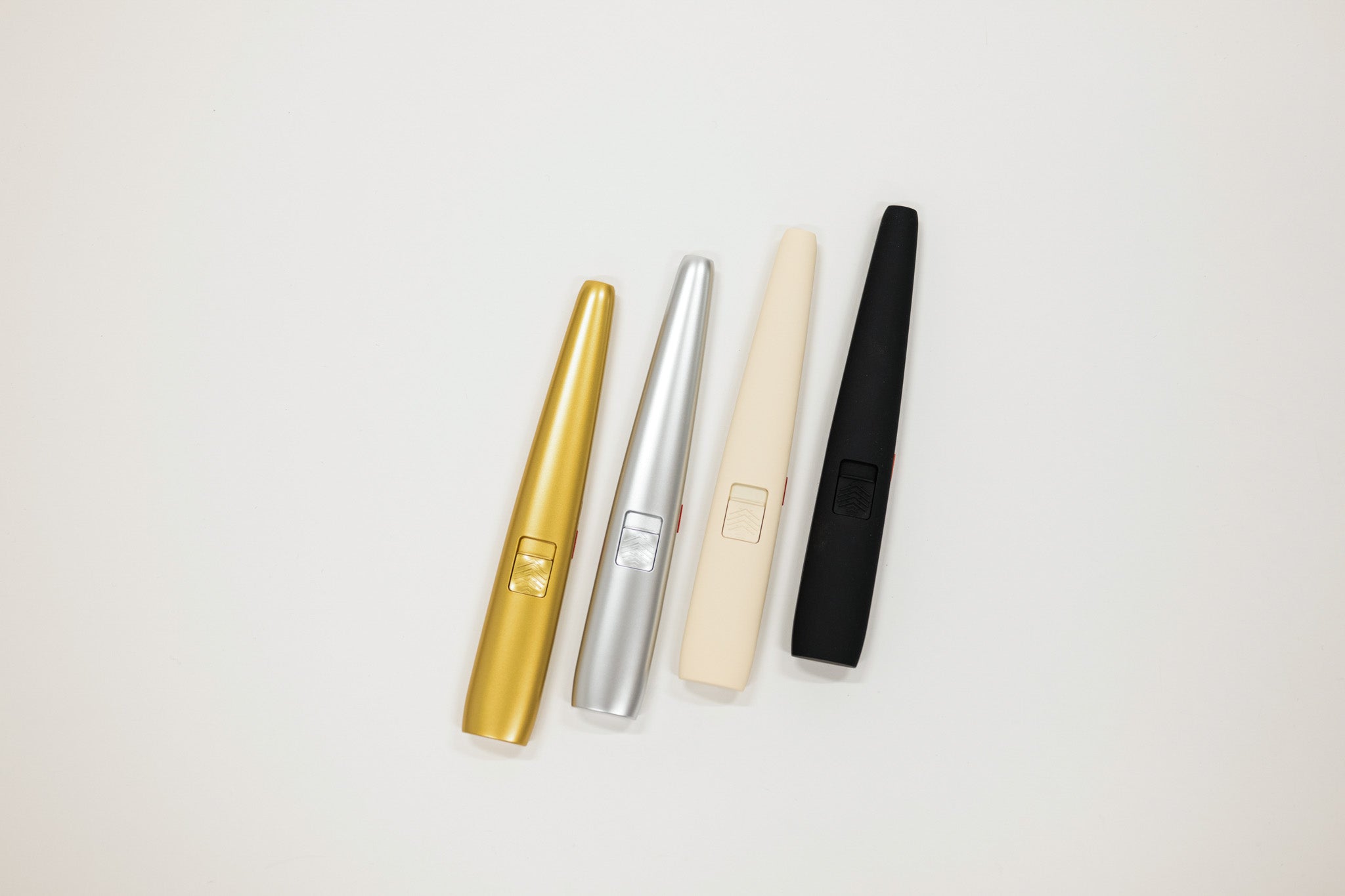 Four usb lighters in gold, silver, beige, and black on a light gray background