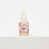A small square bottle of fragrance oil with a white dropper cap, featuring a pink and peach marbled label that reads 'VANILLA BERRY' and 'BECKI OWENS Fragrance Oil' for Pura