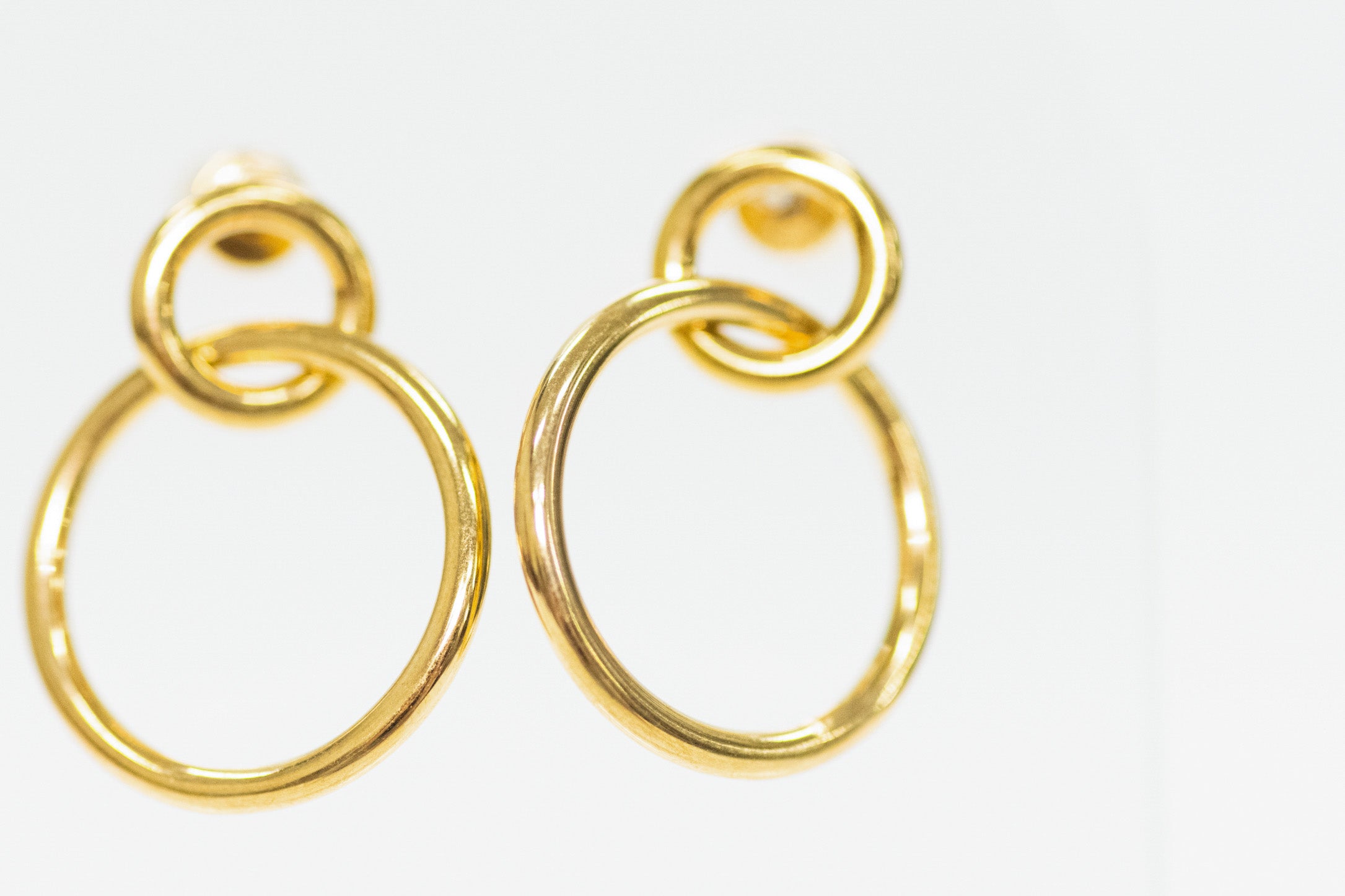 Gold hoop earrings on a white background