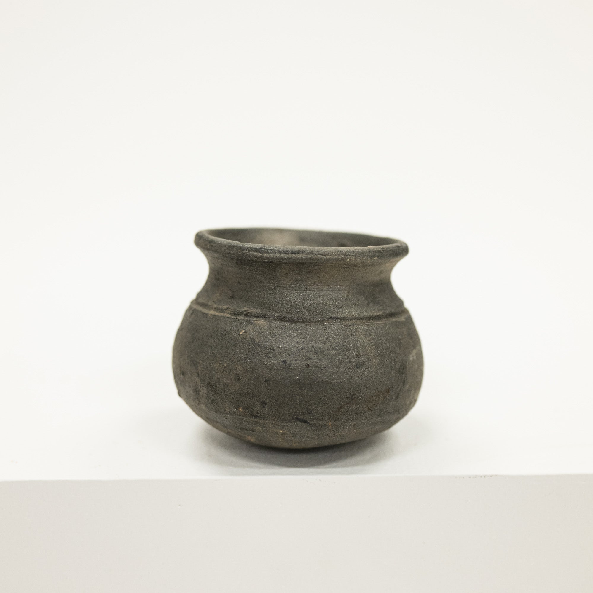 Black ceramic pot on a white background