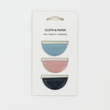 Set of three mini magnetic bookmarks in blue, pink, and navy on Cloth & Paper packaging.