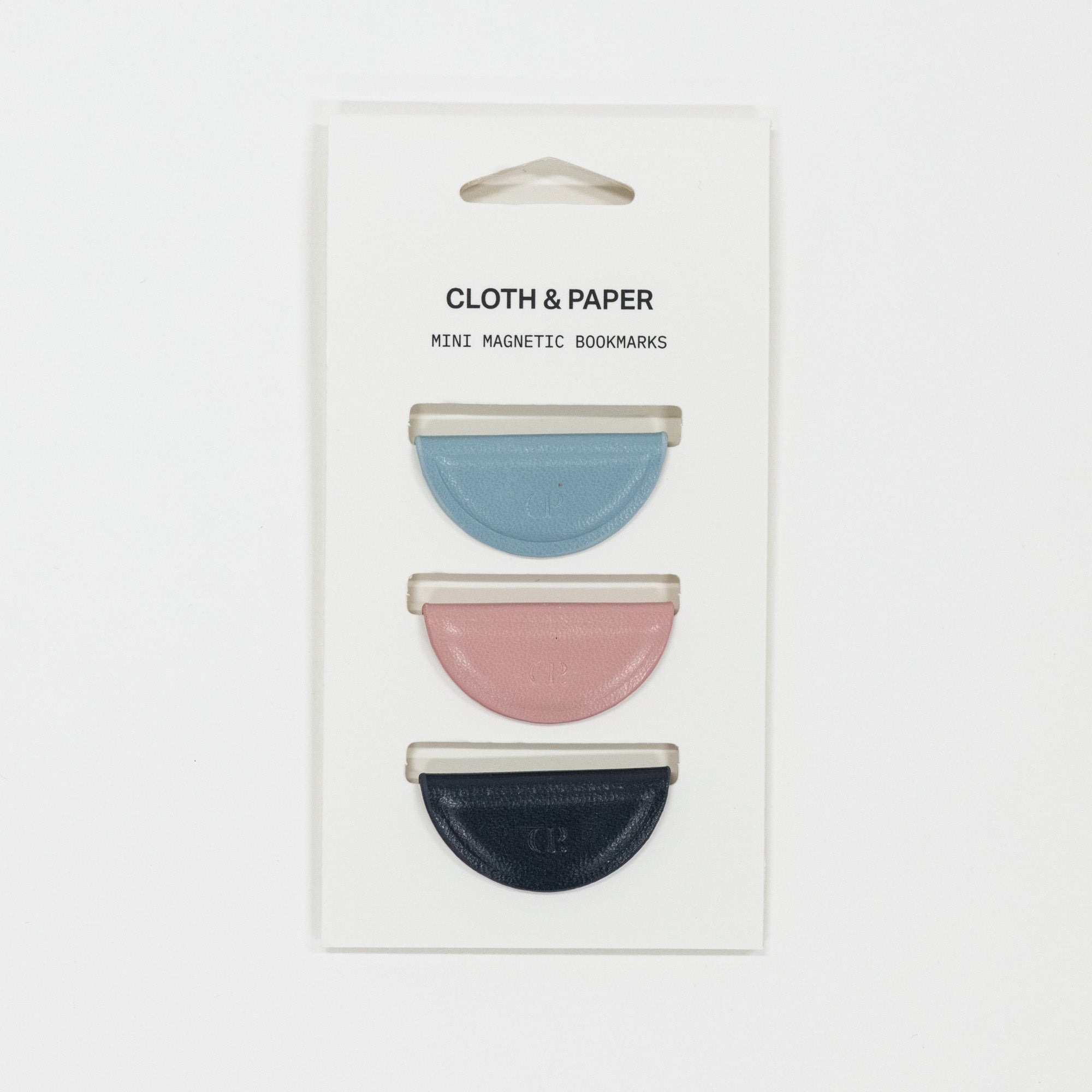 Set of three mini magnetic bookmarks in blue, pink, and navy on Cloth & Paper packaging.
