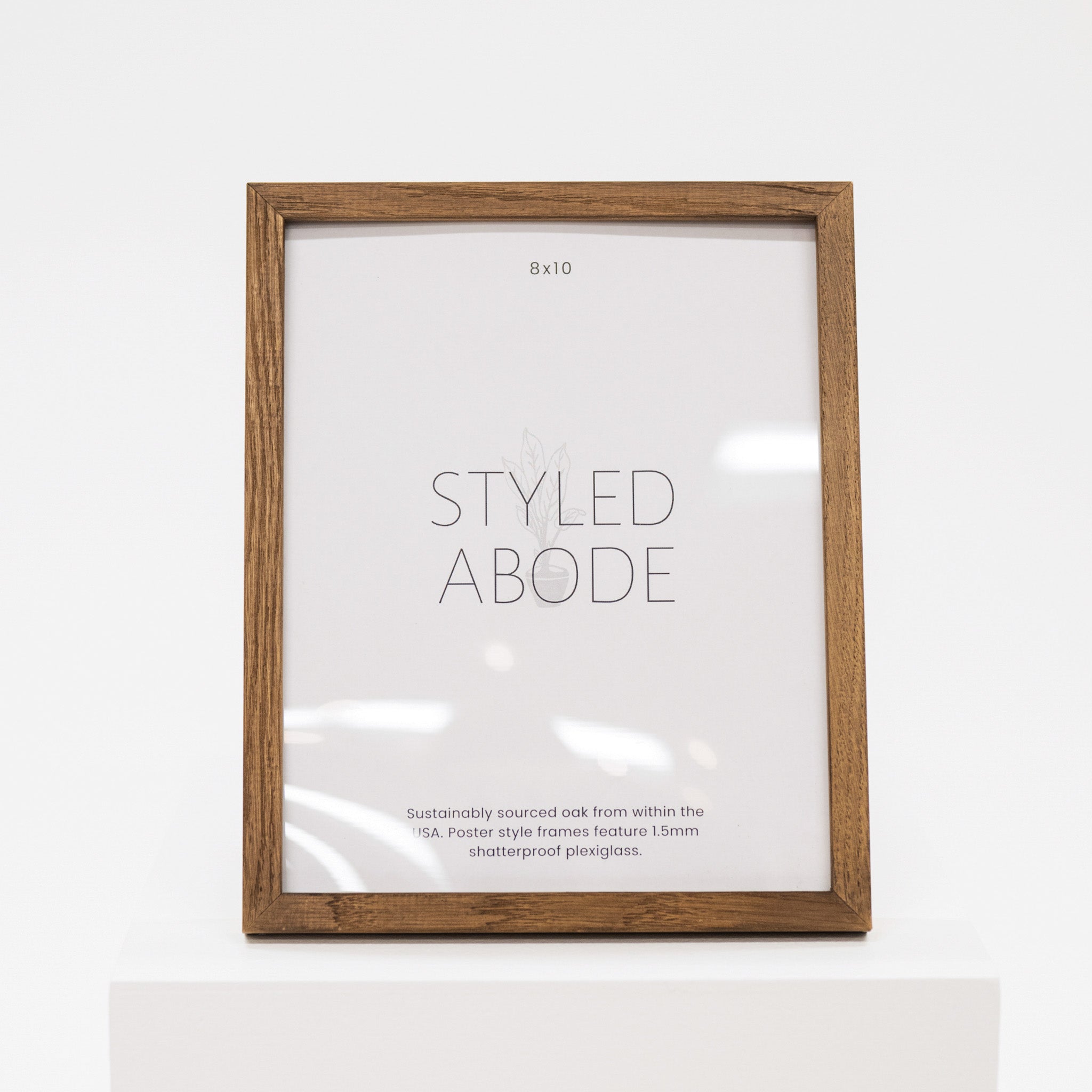 Wooden picture frame with 'Styled Abode' branding on a white background