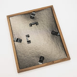 Wooden picture frame with metal hardware on a white background