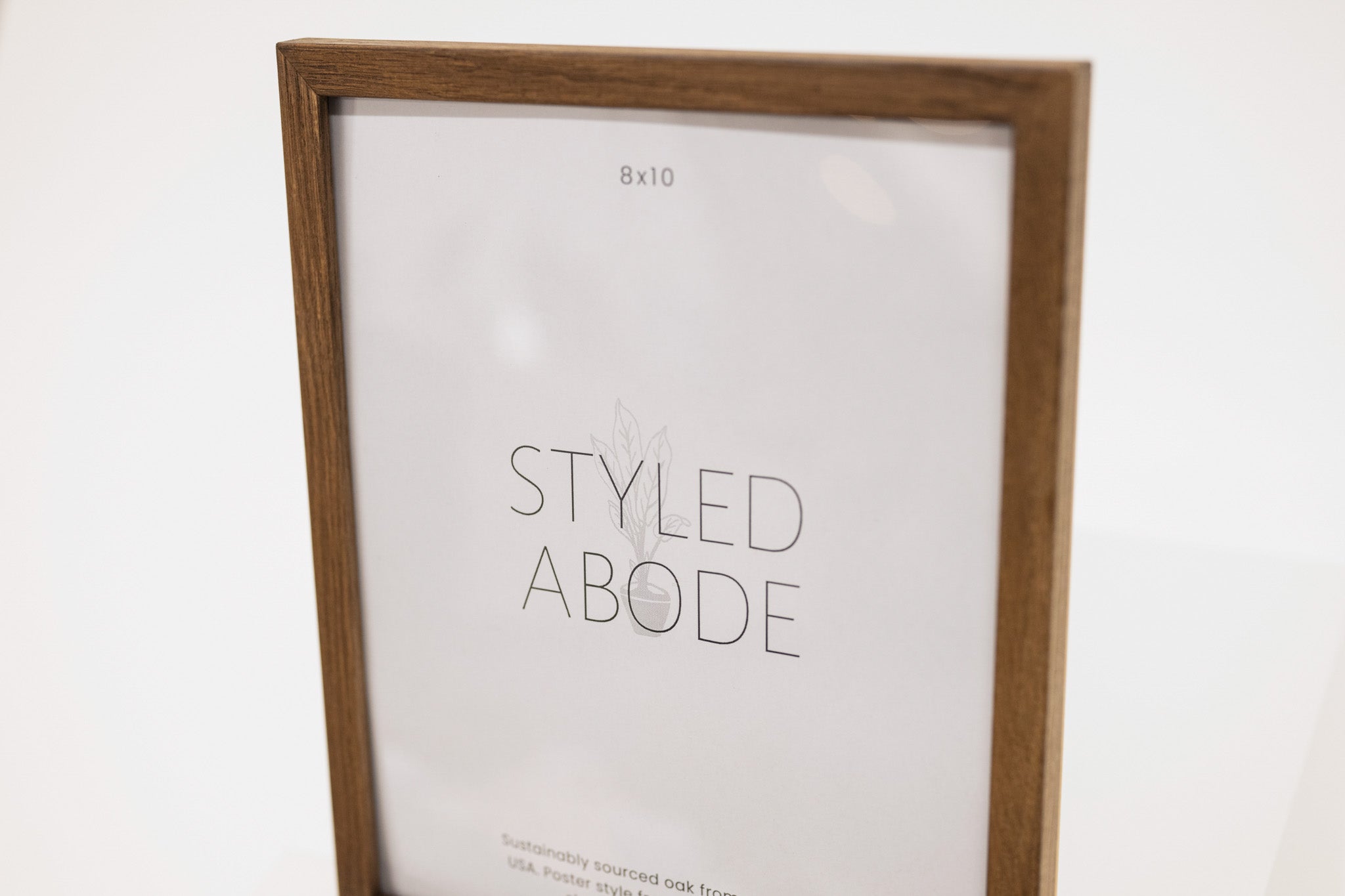 Wooden picture frame with 'Styled Abode' branding on a white background