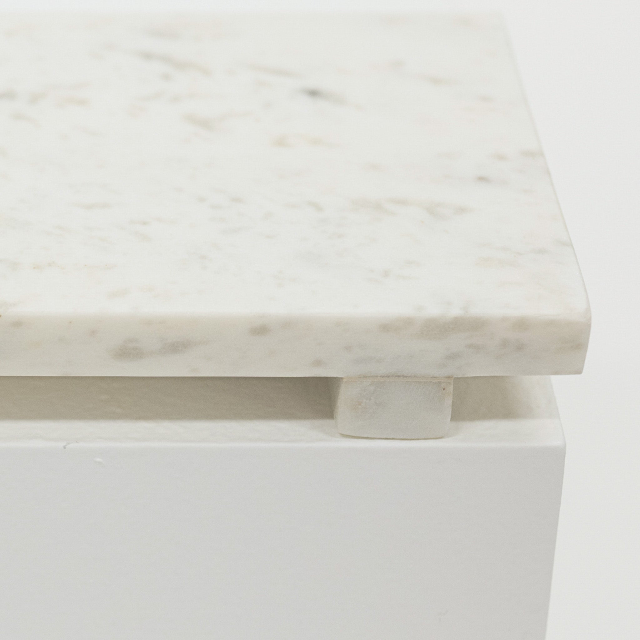 Close-up of a marble riser with a white base on a light gray background