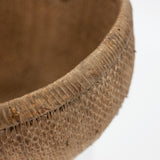 Close-up of a textured brown basket on a white background
