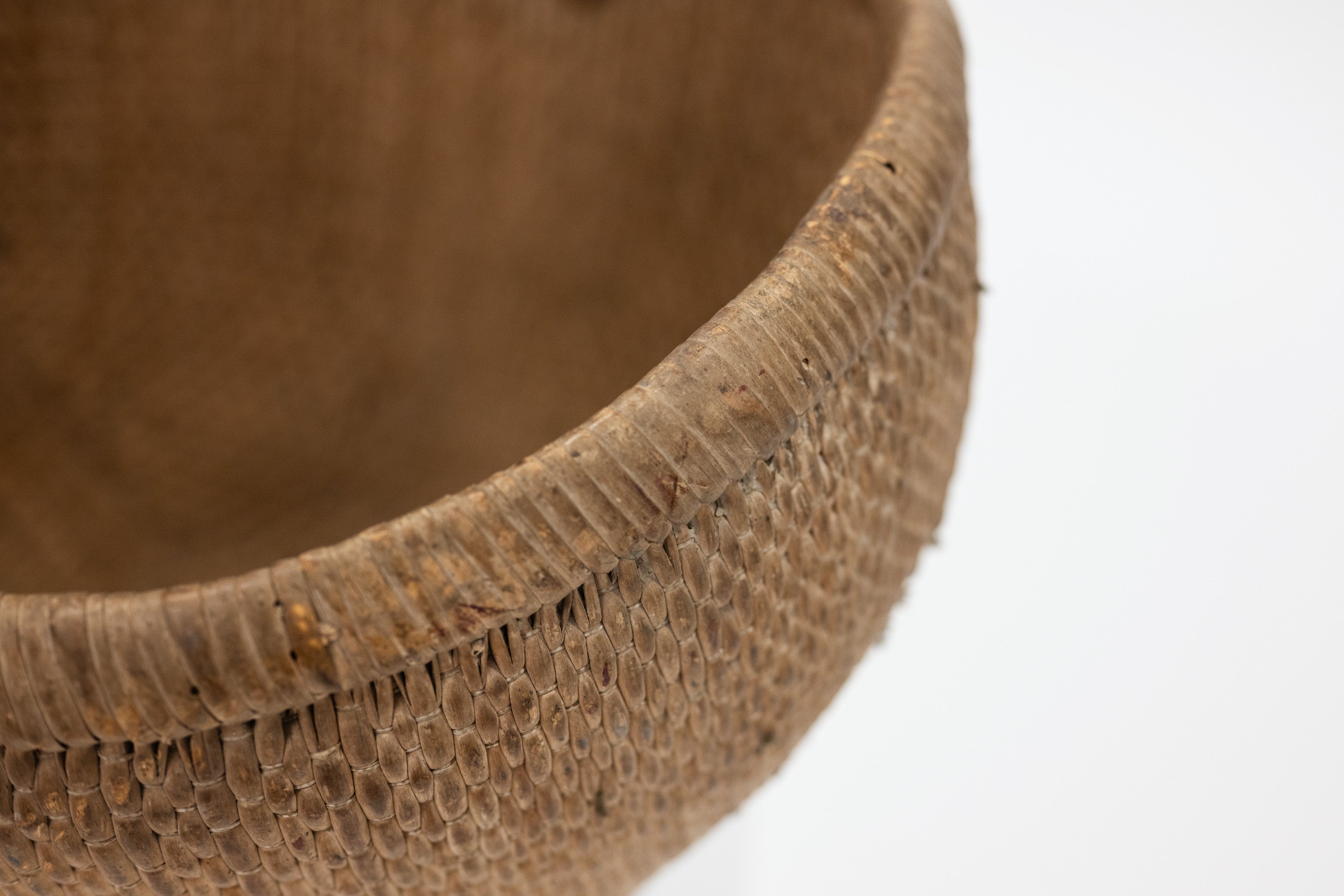 Close-up of a textured brown basket on a white background