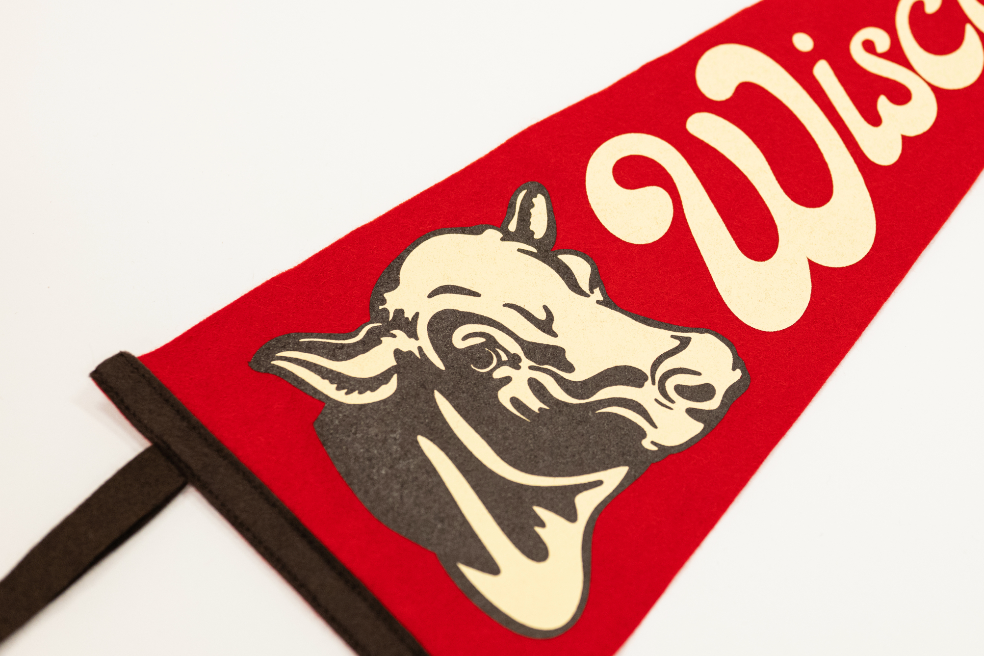 Red flag with cow illustration and 'Wisconsin' text on a white background