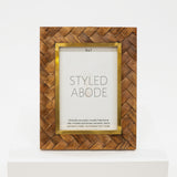 Wooden photo frame with gold accents on a white background