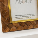 Wooden framed picture with 'ABODE' branding on a white background