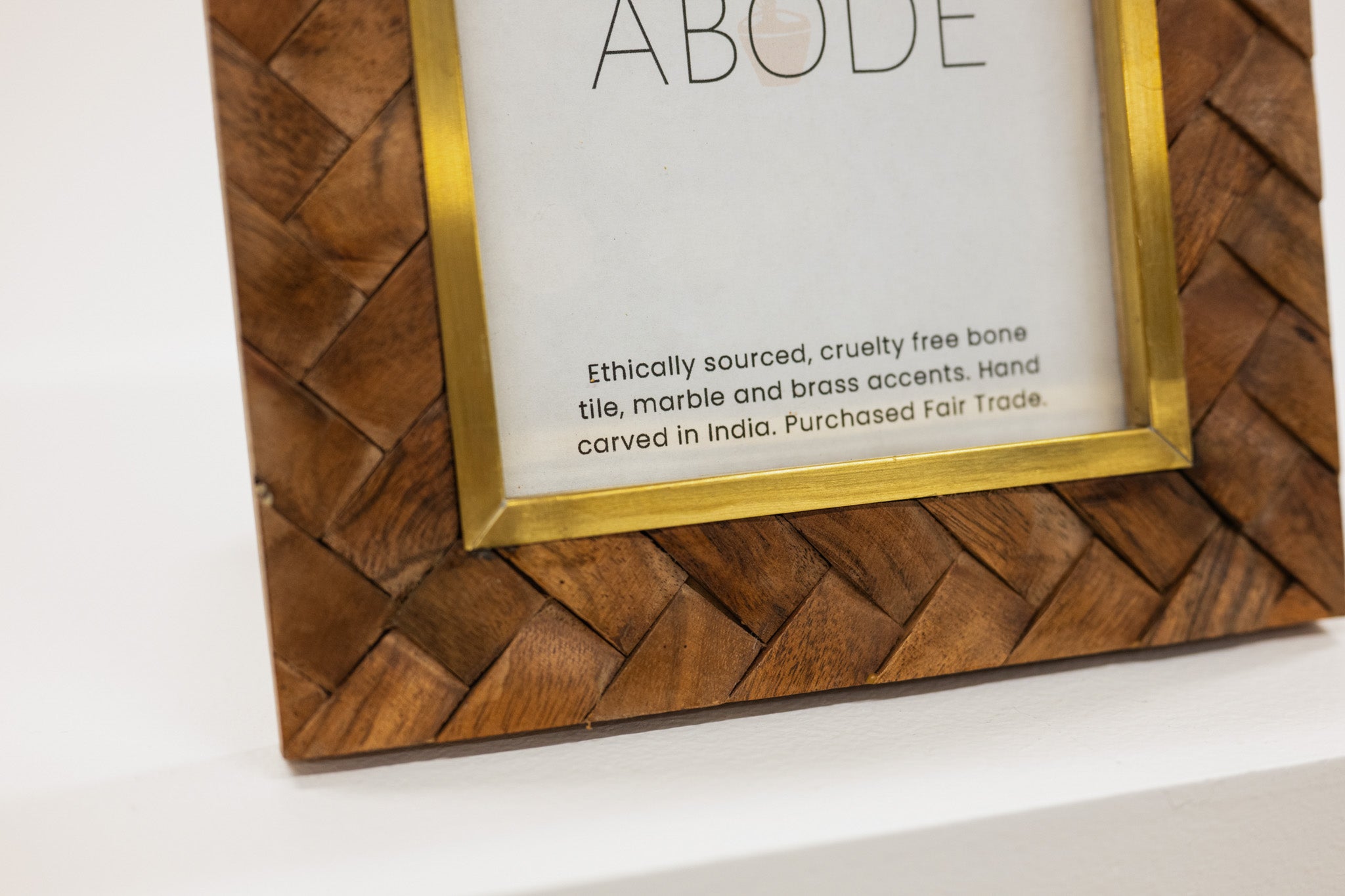 Wooden framed picture with 'ABODE' branding on a white background