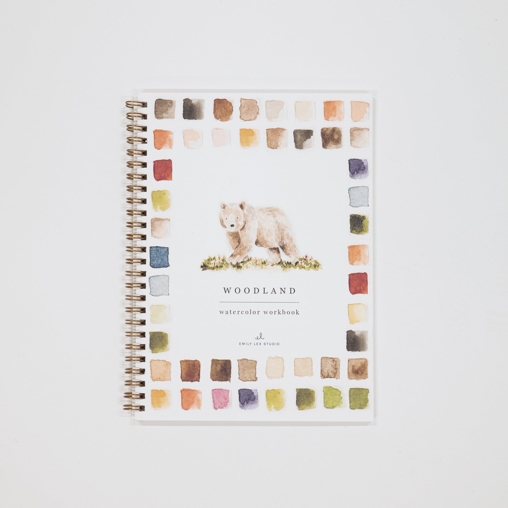 Notebook with bear illustration and watercolor squares on a white background
