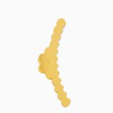 A gold-colored hair claw clip with a wavy, scalloped edge design, shown on a plain white background.