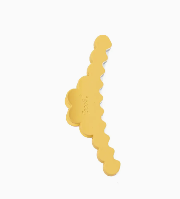 A gold-colored hair claw clip with a scalloped, wavy design, shown on a plain white background.